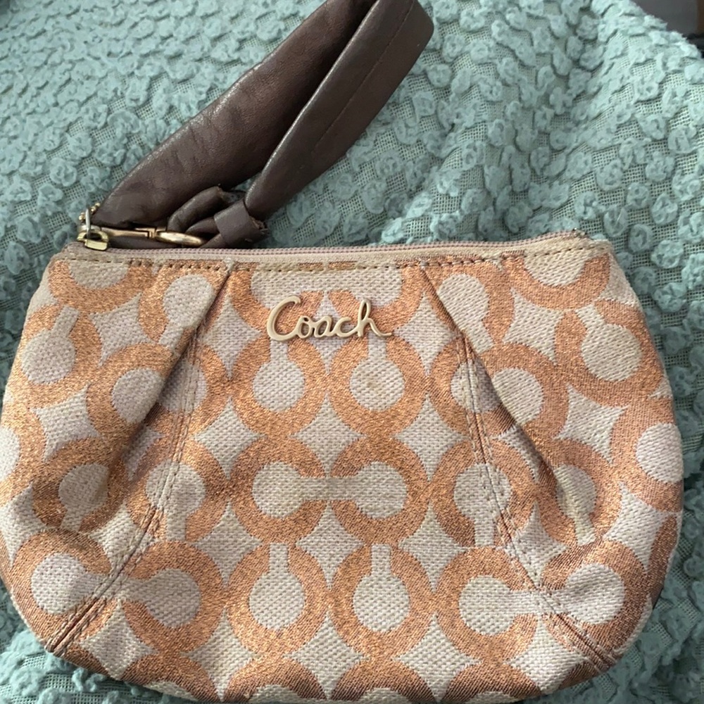 Blush/tan Coach wristlet.